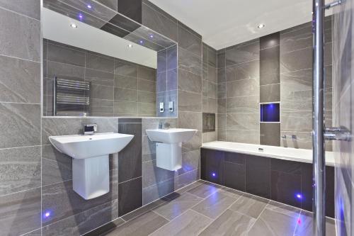 a bathroom with a sink and a toilet and a tub at Diamond Lodge Boutique Adults Only Guest House in Ambleside