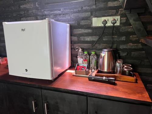 a counter with a refrigerator on top of a counter at Pepper Trails Riverstone 