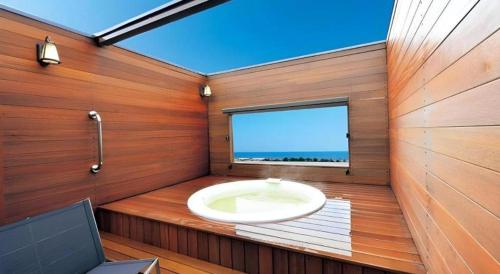a bathroom with a sink in a room with a window at Shirako New Seaside Hotel in Shirako