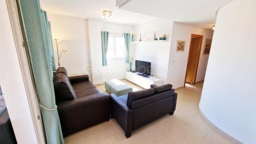 a living room with two leather couches and a television at Spacious Ground Floor Apartment, Free WiFi, Patio, AC in Sucina