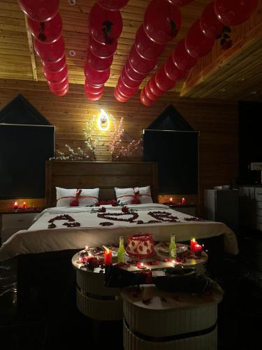 a bedroom with a bed with red lights and candles at اكواخ الهدهد in Ajloun