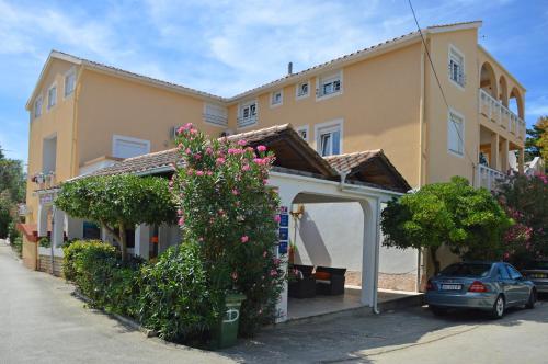 a building with a car parked in front of it at Apartments Eufemija in Novalja