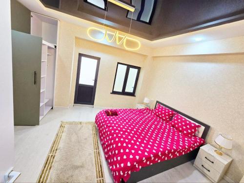 a bedroom with a large pink bed in a room at Comfortable Apartments in Tashkent
