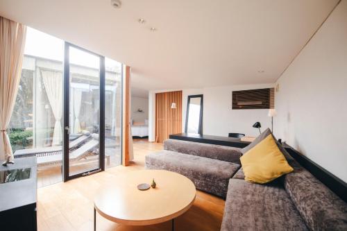 a living room with a couch and a table at 時地人 - JIJIJIN Matsuyama in Tobe