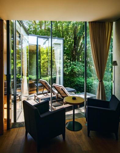 a living room with chairs and a table at 時地人 - JIJIJIN Matsuyama in Tobe