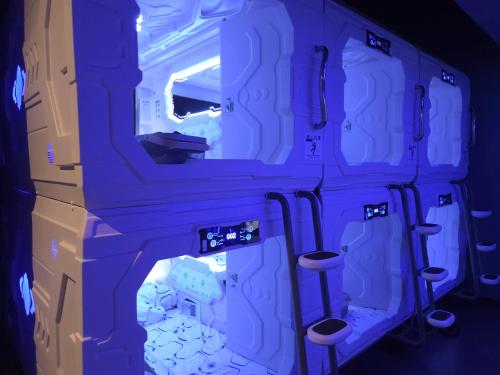 a room with a stack of boxes and stools at Hotel Galaxy Pod 本川越店 in Kawagoe