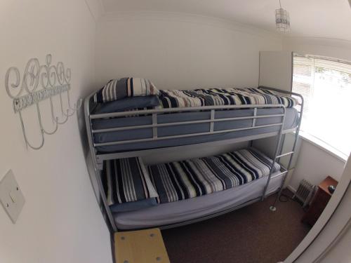 a bedroom with two bunk beds in a room at Crows Nest in Sandown