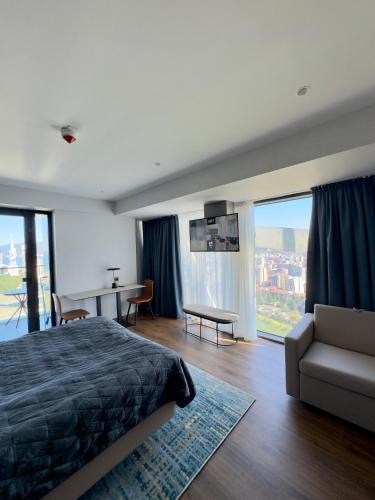 a bedroom with a bed and a table and a couch at Apartment with sea View in Itʼkhvisi