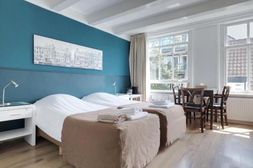 Postel nebo postele na pokoji v ubytování Hotel Prinsenhof Amsterdam