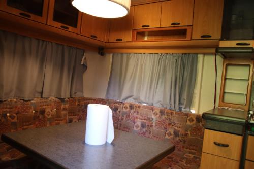 a table with a roll of paper towels on it at Full Service Caravan 3 in Søborg