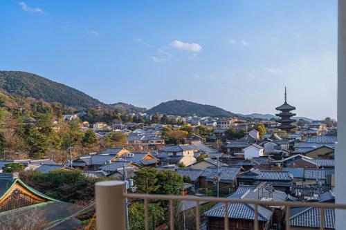 a view of a city with houses and a pagoda at Apartment Hotel 11 Yasaka in Kyoto