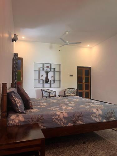 a bedroom with a bed and a ceiling fan at Chitrak stays Jawai in Bijāpur