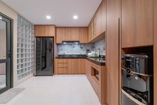 a kitchen with wooden cabinets and a counter top at Palm Stay Residence in Nagoya