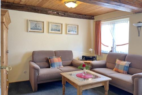 a living room with two couches and a coffee table at Stamp, Hafenstraße in Wyk auf Föhr