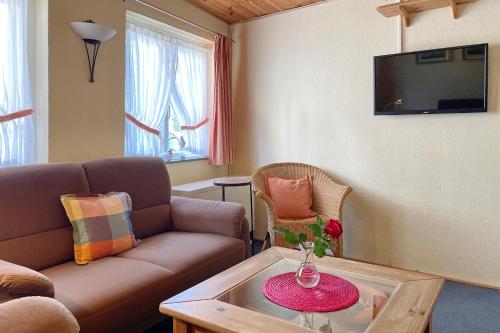 a living room with a couch and a table at Stamp, Hafenstraße in Wyk auf Föhr