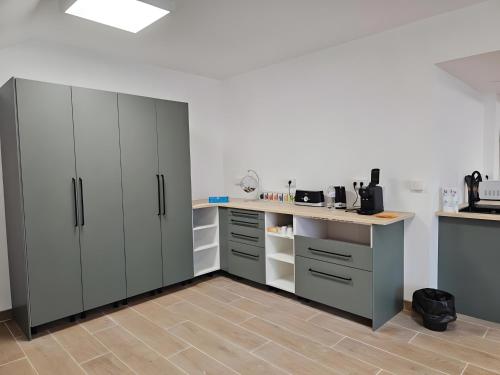 a kitchen with white cabinets and a counter at Villa Milady in Salies-du-Salat