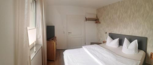 Postel nebo postele na pokoji v ubytování Hafenkoje Arthur