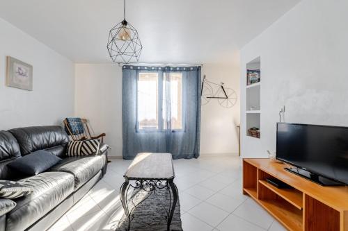 a living room with a couch and a television at Cozy 2 bedroom house - 4 people in Bourg-Saint-Andéol