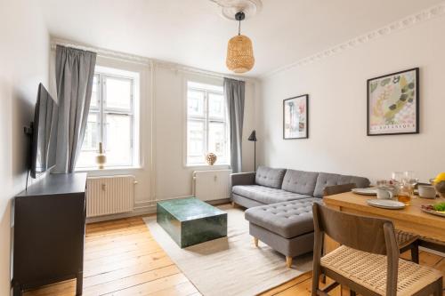 a living room with a couch and a table at Homely 5 Person Apartment in Amager in Copenhagen