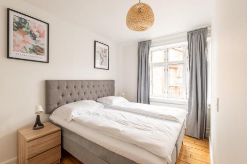 a bedroom with a bed and a window at Homely 5 Person Apartment in Amager in Copenhagen
