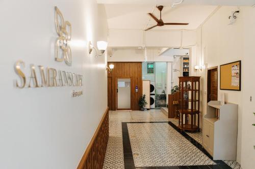 a hallway of a building with a sign on the wall at Samranscape in Bangkok
