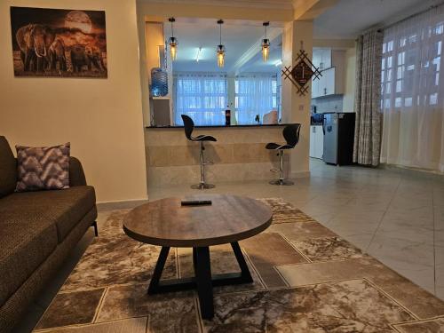a living room with a couch and a coffee table at Pofu Stay Eldoret in Eldoret