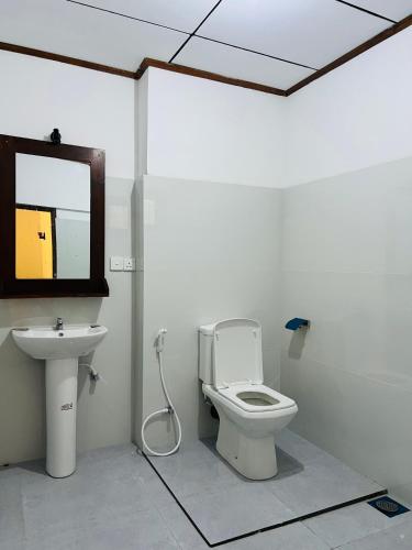 a bathroom with a toilet and a sink at Ganesh Garden Beach Cabanas in Tangalle