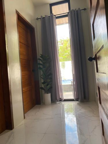 a hallway with a door and a potted plant at Grand Cabins in Panglao Island