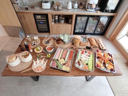 a table with many plates of food on it at Vila Nova Suites & SPA - Adults only TI in Capdepera