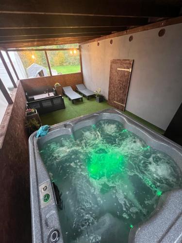 a jacuzzi tub in the middle of a room at VilaEva Adršpach Broumovsko in Ruprechtice
