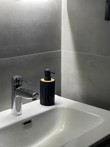a bathroom sink with a black soap dispenser on it at Evergreen Lux in Kopaonik