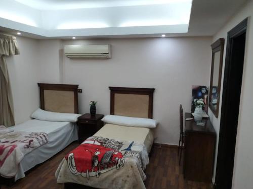 a room with two beds in a room with a window at فندق جاردينيا بلازا- gardinia plaza in Kafr ‘Işām