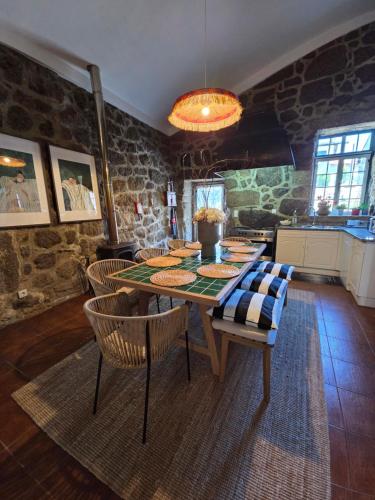 a dining room with a table and some chairs at Villa Moura - Pool & Jacuzzi in Póvoa de Lanhoso
