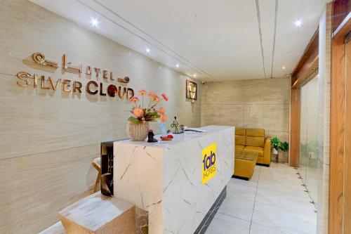 a lobby with a table with flowers on it at FabHotel Silver Cloud in Warangal