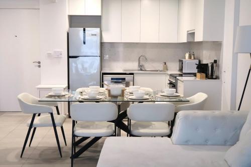 a kitchen with a dining room table and chairs at Burj View Apartment at Madinat Jumeirah Living in Dubai
