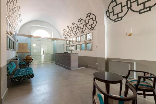 a living room with a table and chairs at Palazzo Fasti in Casarano