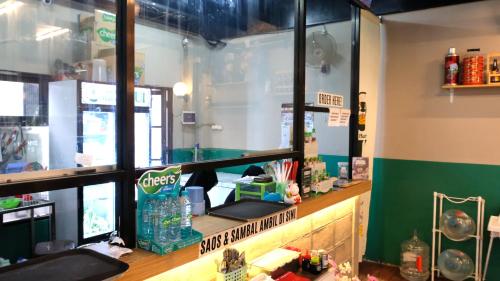 a fast food restaurant with a counter with at Jember Town Square by Calli Rooms in Wirolegi