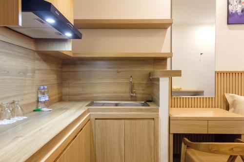 a kitchen with a sink and a counter top at TwoSpaces Living at Bunda Nana Residence, Gianyar in Gianyar