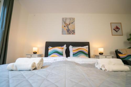 a bedroom with a large white bed with two pillows at Rainbow Studio in Haga & Linné - Prime Location in Gothenburg