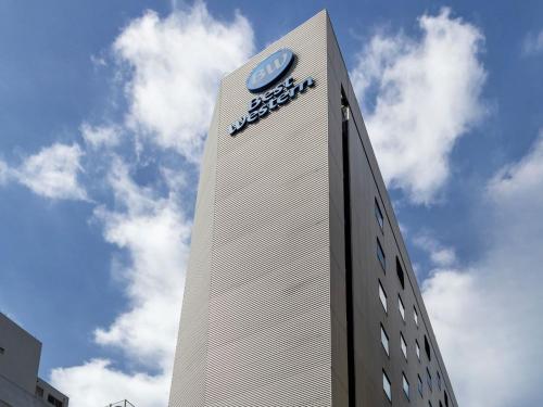 a tall building with a clock on top of it at Best Western Hotel Fino Tokyo Akihabara in Tokyo