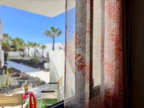 a curtain on a window with a view of a street at Elixir Estate in Antigua