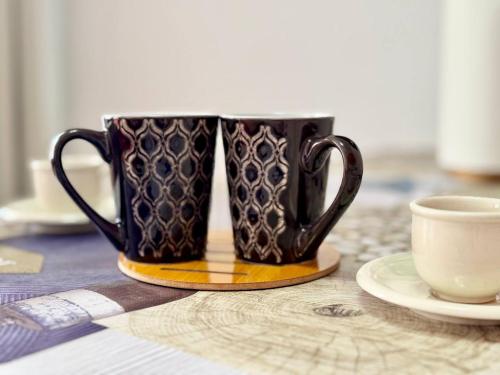 a pair of coffee cups sitting on a table at Elixir Estate in Antigua