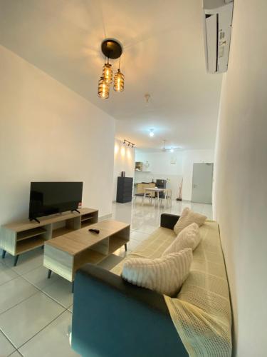 a living room with a couch and a tv at Ai Lee Haven in Papar