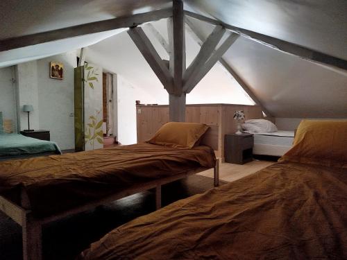 a bedroom with two beds in a attic at Gite de la chapelle in Nogaro