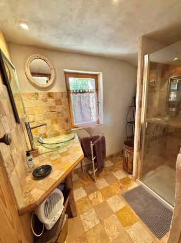 a bathroom with a sink and a shower at L'Oustaou des Monges in Mollans-sur-Ouvèze