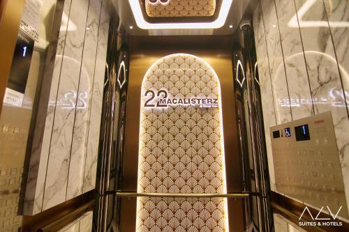a sign on a wall with a snowboard in a room at 22 Macalisterz's Armoire Collection by ALV in George Town