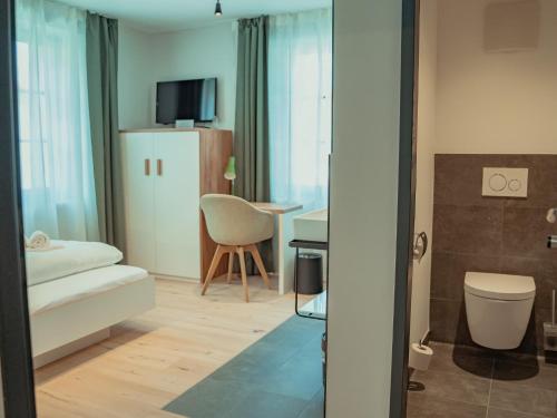 a living room with a bed and a couch and a table at Mariandl im Oberwirt in Eggenfelden