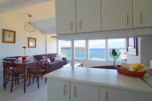 una cucina e un soggiorno con vista sull'oceano di LosLocos beach a Suances