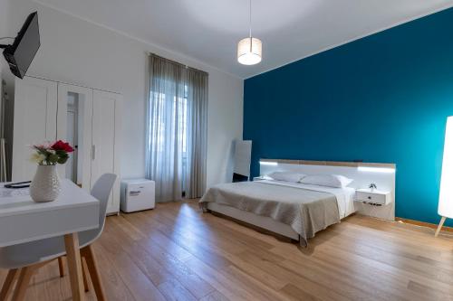 a bedroom with a bed and a blue wall at Moonlight Drive in Cava deʼ Tirreni