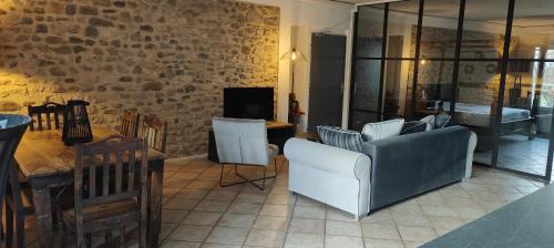 a living room with a couch and a table at Lamaisonxv in Crest